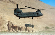 CH-47 Chinook transports a humvee vehicle. 