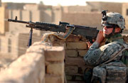 image of moon A soldier stands security watch with an M-240B machine gun.