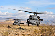Two HH-60 Pavehawk helicopters preparing to land.