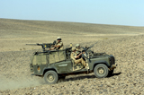 ACH100060M
British soldiers on patrol in a Land Rover in Afghanistan.