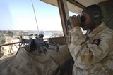 ACH100103M
A soldier looks through binoculars from his outpost.