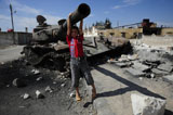 ACH100488M
A young Syrian boy plays on the turret of a destroyed T-72 battle tank.