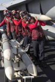 GKR100210M
Ammunition loaders carry an AIM-120 AMRAAM missile.