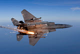 HGP100346M
An F-15 Eagle releases a flare while breaking hard to the left.