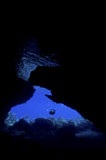 MME400417U
Diver with lights entering a submerged cave, Australia.