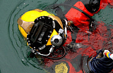 STK0045MX
U.S. Navy Diver is lowered into the water during a pier repair operations dive.