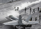 STK100205M
An F/A-18C Hornet taxies to a steam-powered catapult on the flight deck of USS Theodore Roosevelt.