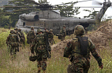 STK100586M
Marines approach a landing zone for extraction as a CH-53D Sea Stallion helicopter awaits them.