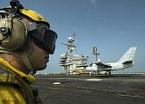 STK100847M
Aviation Boatswain Mate looks-on as an S-3B Viking makes an arrested landing.
