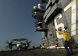 STK100848M
Signalman directs the movement of an E-2C Hawkeye across the flight deck of USS John F. Kennedy.