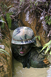 STK100882M
A Seabee low-crawls through a trench.