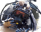 STK100891M
Diver inspects his outfit after a plunge.