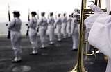 STK101001M
Ceremonial Honor Guard members stand at port arms during a burial at sea ceremony.