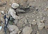 STK101140M
A combat engineer carefully scoops dirt away from a stack of mortar shells.