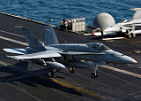 STK101144M
An F/A-18 Hornet makes an arrested landing aboard aircraft carrier USS Theodore Roosevelt.