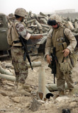 STK101739M
An infantryman inspects spent artillery shells.