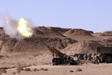 STK101765M
Flame and smoke emerge from the muzzle of an M198 Howitzer.