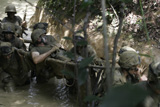 STK101791M
Marines trudge through the mud of Peanut Butter Alley.