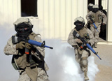 STK101843M
Marines cross a danger area after using a smoke grenade to conceal their movement.