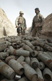 STK101911M
Marines stand over a pile of unused ordnance.