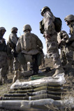 STK101919M
Marines and Iraqi soldiers gather around a weapons cache.