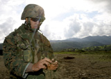 STK101930M
A squad leader prepares a time fuse for a Bangalore Torpedo.