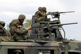 STK101972M
Machine gunners fire machine guns from atop of Light Armored Vehicles.