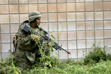 STK102083M
A squad automatic weapon gunner posts security.