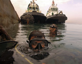 STK102086M
Navy divers inspect a pier at the Port of Djibouti City.