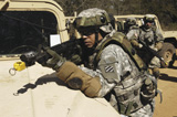STK102273M
A U.S. Army Soldier pulls security over the hood of a humvee.