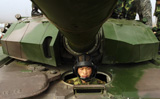 STK102300M
A Chinese tanker soldier with the People's Liberation Army sits in his tank.