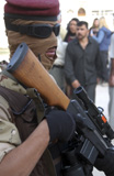 STK102420M
An armed Iraqi Army guard provides security.