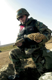 STK102429M
Soldier shows the remains of a Korean War-era bazooka round.