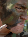 STK102458M
Airman applies war paint to his face.