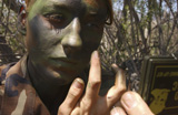 STK102461M
Airman applies camouflage paint to her face.