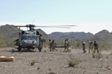 STK102547M
Pararescuemen transport rescuees to an awaiting HH-60 Pave Hawk.