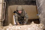 STK102604M
Airman climbs to the top of a lookout point.
