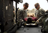 STK102718M
Medical technicians load an Iraqi trauma patient onto an Iraqi Air Force Huey II.