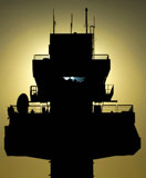 STK102847M
The setting sun silhouettes an air traffic control tower