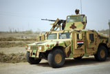 STK102896M
An Iraqi soldier provides security while his fellow soldiers fix a disabled vehicle.