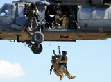 STK102982M
Pararescuemen are hoisted into an HH-60 Pavehawk helicopter.