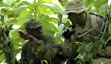 STK103020M
A Scout receives observational information from a Beninese Army officer.