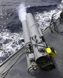 STK103078M
The guided missile destroyer USS Mustin (DDG-89), test fires the MK-32 Mod-15 Torpedo Launcher.
