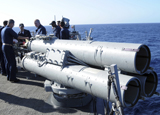 STK103136M
Crew members aboard the guided-missile destroyer USS Porter loading a Mark 46 recoverable exercise torpedo.