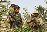 STK103520M
Iraqi soldiers conduct a foot patrol in Al Madinia, Iraq.