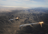 STK103564M
A two-ship of  B-1B Lancers release chaff and flares while maneuvering over New Mexico.