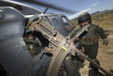STK103670M
Soldiers prepare to reload a .50 caliber machine gun on an HH-60 Pave Hawk.