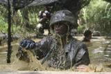 STK103709M
A Marine splashes as he makes his way through an obstacle course at the Jungle Warfare Training Center.