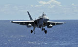 STK103806M
An F/A-18C Hornet approaches the flight deck of the aircraft carrier USS Ronald Reagan.