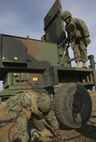 STK103828M
Marines prepare the antenna of an AN/TPQ-46A radar system.